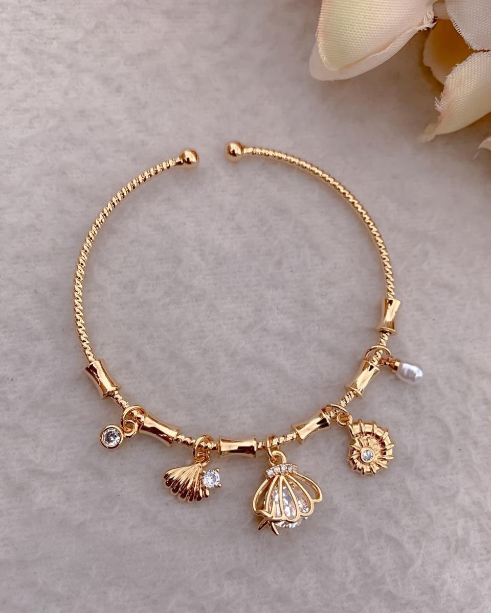Handcrafted Artisanal Gold Charm Bracelet with Pearl & Shell Motifs
