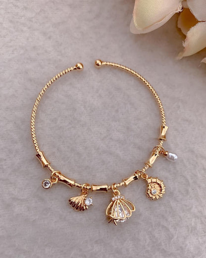 Handcrafted Artisanal Gold Charm Bracelet with Pearl & Shell Motifs
