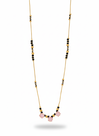 Necklace with pink beads and gold chain on a white background