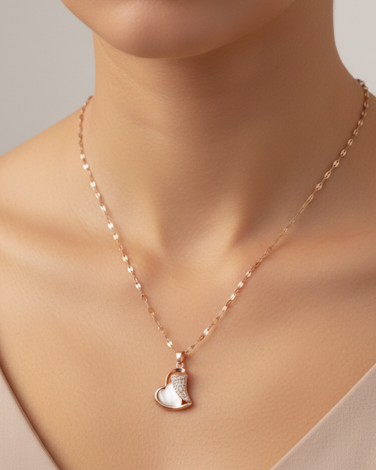 Rose gold necklace with a heart-shaped pendant on a mannequin